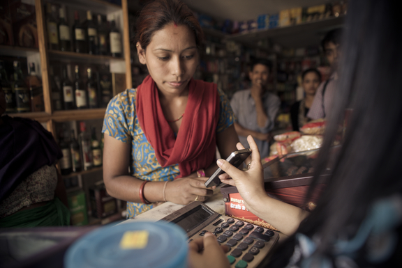 Testing a new system of emergency assistance in Nepal. Recipients receive virtual vouchers via SMS message on mobile phones that can be used like cash at participating local stores. Photo: Suraj Shakya for Mercy Corps.