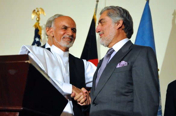 Afghan presidential candidate Ashraf Ghani shakes hands with rival candidate Abdullah Abdullah after both addressed reporters at the United Nations Mission Headquarters in Kabul, Afghanistan on July 12, 2014, about the details of an agreement on a technical and political plan U.S. Secretary of State John Kerry helped broker to resolve the disputed outcome of the election between him and Abdullah.