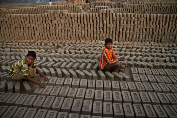Young boys turning over bricks at one of the hundreds of outdoors kilns that ring Bangladesh's capital of Dhaka.  Across South Asia, boys and girls are recruited to manual labor positions in order to help provide for their families. Often, this means that they must drop out of school in order to help the family get enough money for food and shelter. Other times, children are forcibly kidnapped and taken to other parts of the subcontinent to work as slave labor as domestic servants, prostitutes, or other undesirable professions​.  Photo and caption: Jason Miklian, RIO