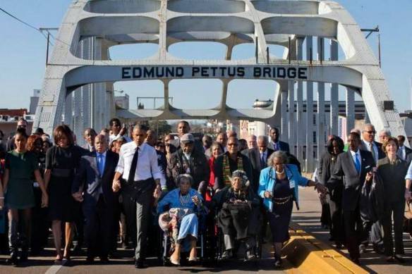 Celebration at the Edmund Pettus bridge, Selma, 7 March 2015. John Lewis between Michelle and Barack Obama. Photo: The Kansas City Star