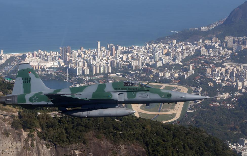 A Brazilian Air Force plane flies during an exercise ahead the Rio 2016 Olympic Games in Rio de Janeiro, Brazil. REUTERS/Stringer